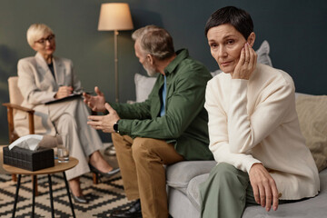 Obraz premium Portrait of distressed mature woman looking away during couples therapy session or counselling