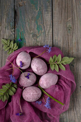 Still life of beautiful textured purple eggs on purple gauze