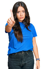 Beautiful brunette young woman wearing casual clothes pointing with finger up and angry expression, showing no gesture