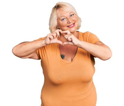 Middle age blonde woman wearing casual clothes smiling in love showing heart symbol and shape with hands. romantic concept. - Powered by Adobe