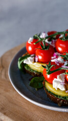 A Gourmet Vegetarian Feast Featuring Fresh Tomatoes and Avocado on a Rustic Table