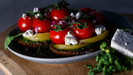 A Gourmet Vegetarian Feast Featuring Fresh Tomatoes and Avocado on a Rustic Table