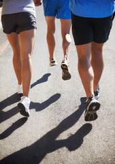 People, fitness and legs running for workout, fitness or outdoor exercise together on asphalt or...