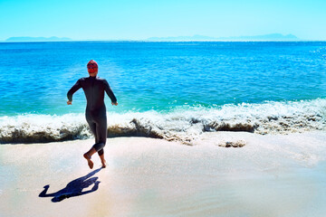 Swimming, back and woman running to sea at beach in summer for exercise, training or workout on mockup space. Ocean, sport and rear view of athlete at water outdoor for fitness, health or triathlon
