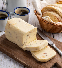 Requeijao de corte, traditional brazilian country cream cheese with coffee and bread over wooden table