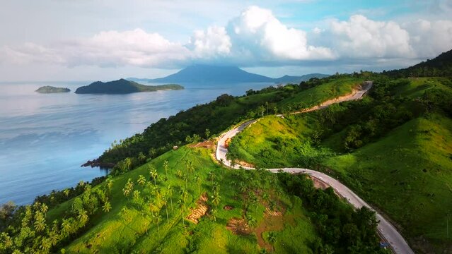 Aerial view of a scenic road along the coastline with high cliffs and beautiful beach in San Vicente Viewpoint, Palawan, Philippines.