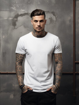 Oversize white style t-shirt mockup photo with handsome man with tattoos and light concrete background 