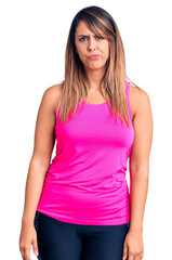 Fototapeta premium Young beautiful woman wearing sportswear depressed and worry for distress, crying angry and afraid. sad expression.