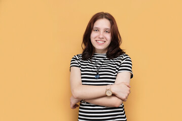 Fototapeta premium Portrait of a happy teenage girl with big beautiful eyes, white teeth, the girl is smiling and happy that she has many friends, she is very positive and sociable, advertising