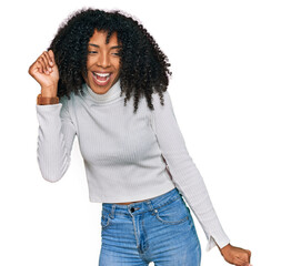 Young african american girl wearing casual clothes dancing happy and cheerful, smiling moving casual and confident listening to music