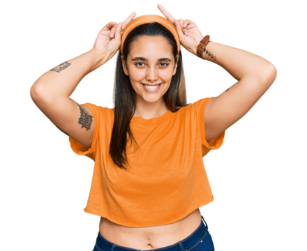 Young hispanic woman wearing casual clothes posing funny and crazy with fingers on head as bunny ears, smiling cheerful
