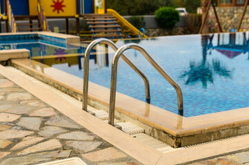 Fototapeta na wymiar handrails ladder in a swimming pool in a residential complex3