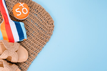 Creative concept of sunscreen 50 level protection and accessories on a blue background. Sun...