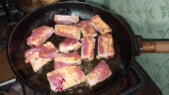 Pork ribs fried in a frying pan