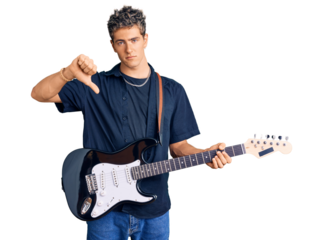 Young handsome man playing electric guitar with angry face, negative sign showing dislike with thumbs down, rejection concept