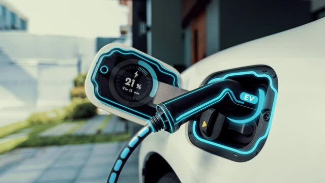 Electric car recharging in futuristic home charging station with smart digital EV battery status hologram. Technology advancement of EV car and home energy infrastructure for sustainable future.Peruse