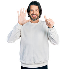 Middle age caucasian man wearing casual clothes showing and pointing up with fingers number six while smiling confident and happy.