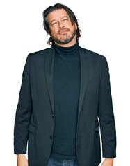 Middle age handsome man wearing business clothes relaxed with serious expression on face. simple and natural looking at the camera.