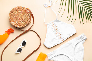 Composition with beach accessories and palm leaf on beige background