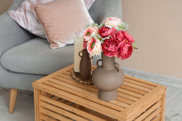 Vase with beautiful peony flowers on wooden table in living room, closeup