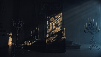 Large carved wooden throne in a dark church room