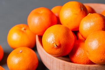 clementine mandarin fruit. mandarins in the wooden bowl.