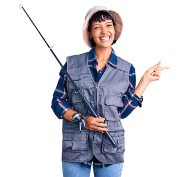 Young brunette woman with short hair wearing fisherman equipment smiling happy pointing with hand and finger to the side