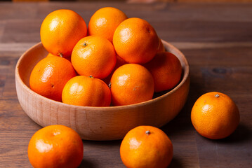 clementine mandarin fruit. mandarins in the wooden bowl.