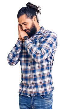 Young arab man wearing casual clothes sleeping tired dreaming and posing with hands together while smiling with closed eyes.