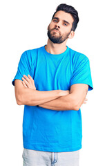 Young handsome man with beard wearing casual t-shirt skeptic and nervous, disapproving expression...