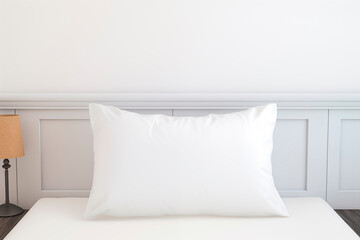 White pillow on bed in bedroom. White satin bedding set. mockup.