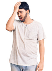Fototapeta premium Young hispanic man wearing casual clothes surprised with hand on head for mistake, remember error. forgot, bad memory concept.