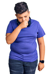 Little boy kid listening to music wearing headphones feeling unwell and coughing as symptom for cold or bronchitis. health care concept.