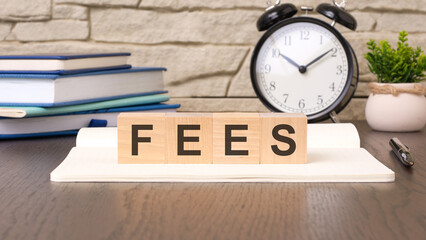 cubes form the word fees. scam word concept - finance, market and investment - obrazy, fototapety, plakaty