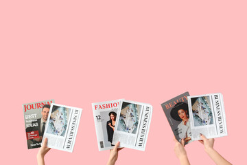 Women with newspapers and magazines on pink background