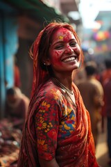Joyful woman with face covered in Holi colors, traditional attire