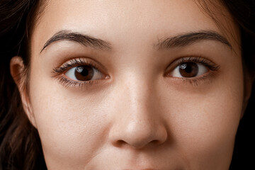 Young Asian woman with brown eyes, closeup