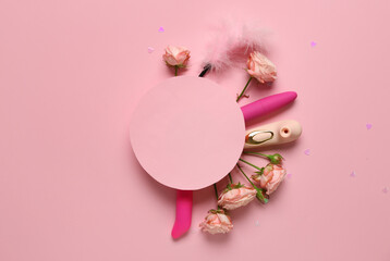 Composition with blank card and different sex toys on pink background