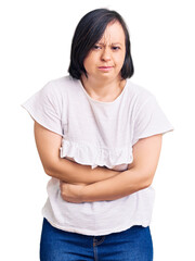 Fototapeta premium Brunette woman with down syndrome wearing casual white tshirt with hand on stomach because indigestion, painful illness feeling unwell. ache concept.