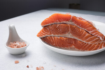 fresh, delicious salmon fillet on a white plate