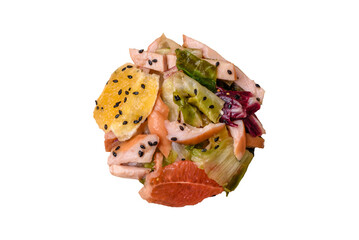 Delicious fresh juicy salad of sliced chicken, grapefruit, lettuce, sesame with olive oil