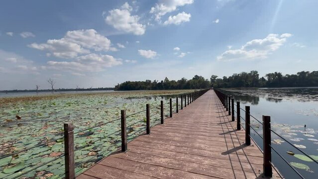 Walking along the causeway towards the island of Baray of Jayatataka and the temple Neak Pean (or Neak Poan), built under King Jayavarman VII, at Angkor, Siem Reap, Cambodia.