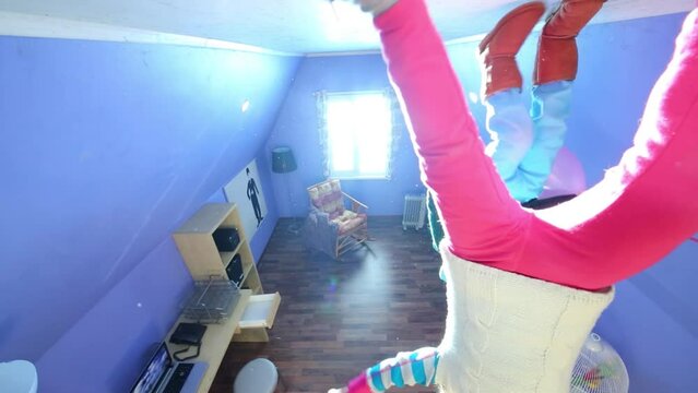 Little girl and boy walk on ceiling upside down at inverted house