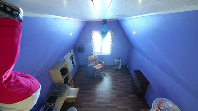 girl stands on ceiling at inverted house and boy looks to window