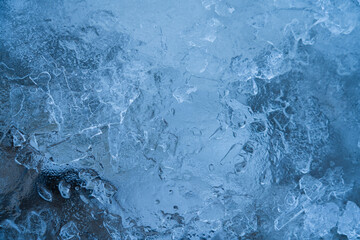 Icy winter background cracked grunge texture. Natural scratched ice on a skating rink as a texture or background for a winter composition, large long painting