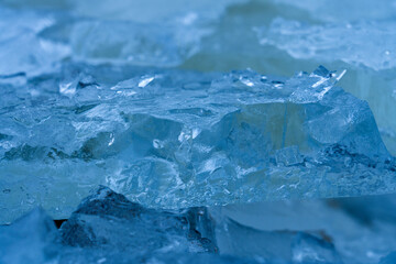 Icy winter background cracked grunge texture. Natural scratched ice on a skating rink as a texture or background for a winter composition, large long painting