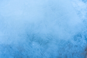 Icy winter background cracked grunge texture. Natural scratched ice on a skating rink as a texture or background for a winter composition, large long painting