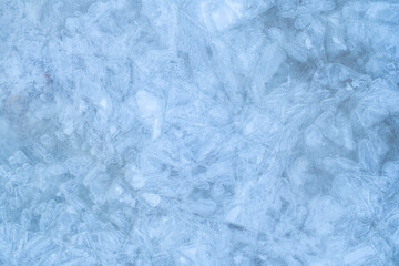 Icy winter background cracked grunge texture. Natural scratched ice on a skating rink as a texture or background for a winter composition, large long painting