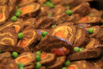 Brown rolled meat roulades are neatly arranged on the table