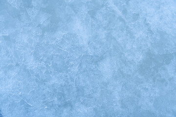 Icy winter background cracked grunge texture. Natural scratched ice on a skating rink as a texture or background for a winter composition, large long painting
